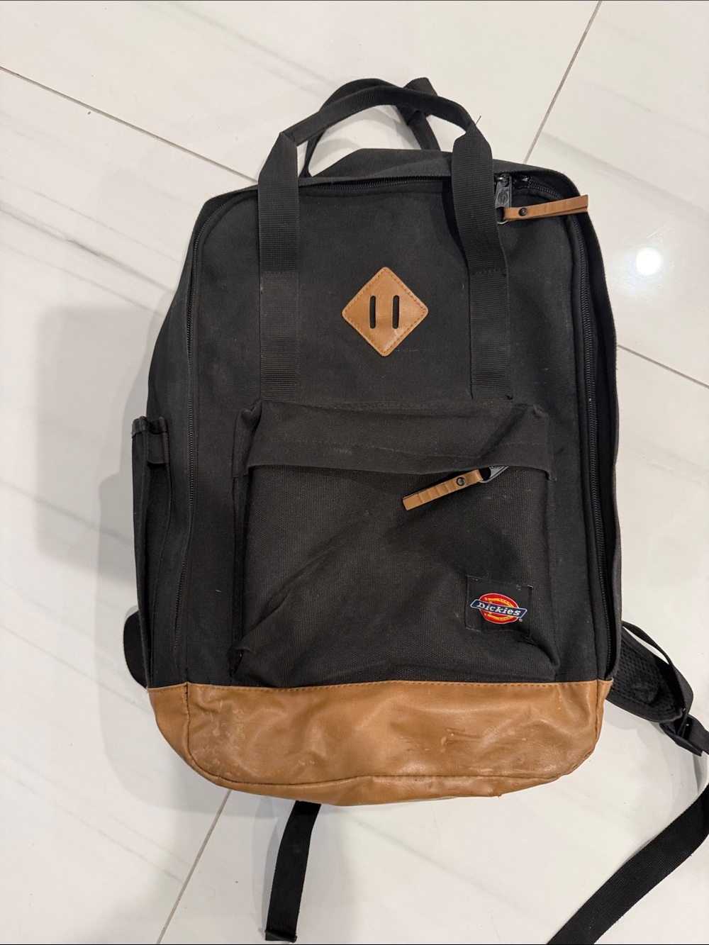 Dickies Black Canvas Backpack with Brown Genuine Leather Bottom.